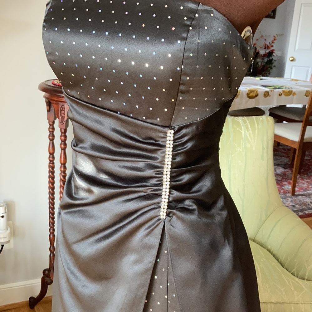 Blonde Nites long black satin strapless gown.